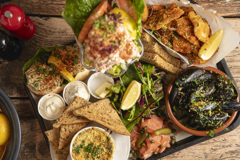 A Crabshack sharing seafood platter with crab, smoked salmon, mussels and fresh bread