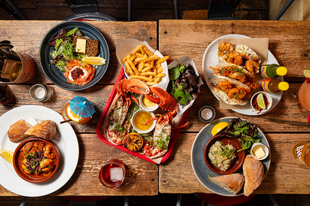 Seafood dishes and drinks laid out at Crabshack Worthing