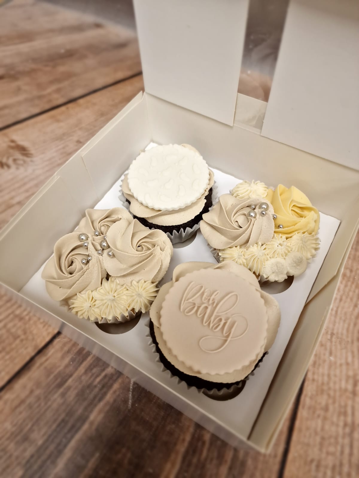 Boxed celebration cake and cupcakes iced in sage green with hearts
