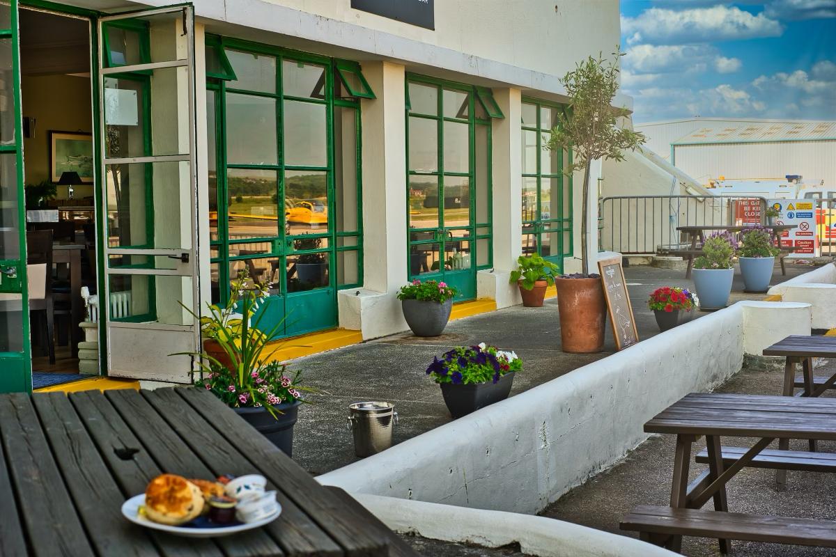 The Hummingbird restaurant terrace at Shoreham Airport with cream teas and a runway view