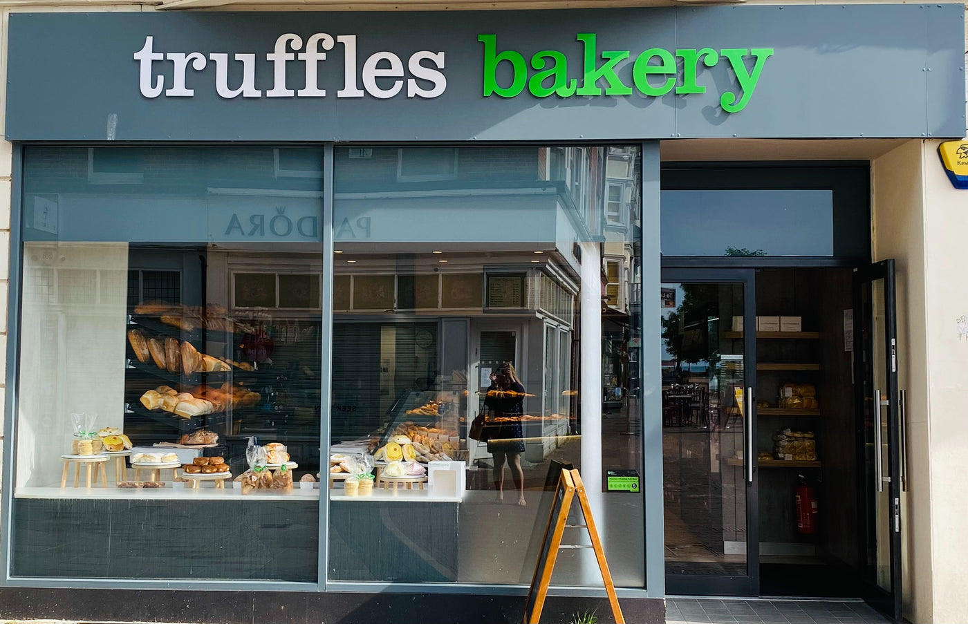 The Truffles Bakery shop window in Worthing, stacked with fresh bread and bakes